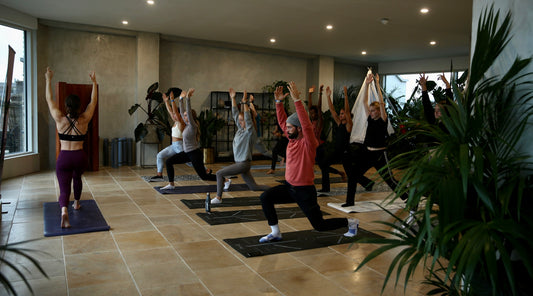 The Gym+Coffee +Pause event in London where participants are taking part in a Yoga session led by Tiffany Soi.